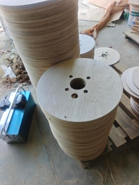 Plywood Cable Reel Flanges — Finished flange discs stacked in workshop