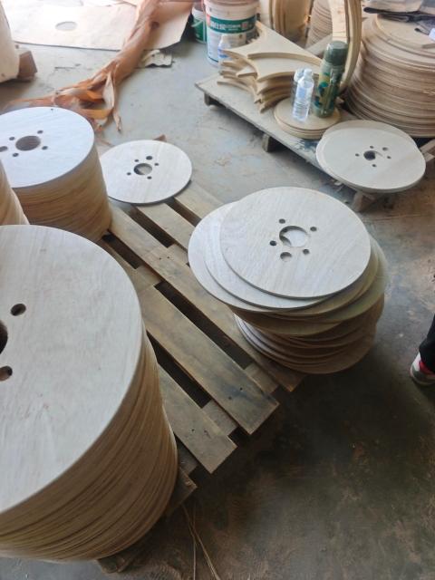 Plywood Cable Reel Flanges — Drilled flange components on production floor
