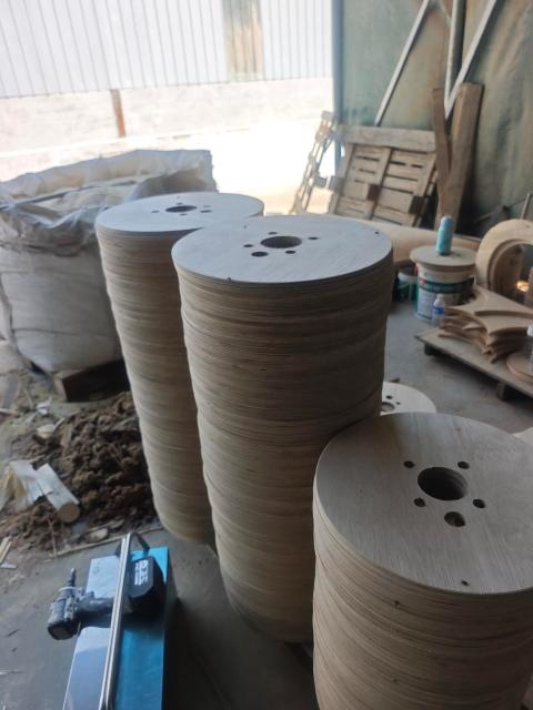 Plywood Cable Reel Flanges — Circular flange discs with center holes piled in workshop
