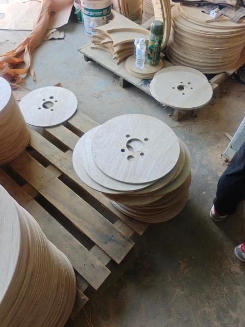 Plywood Cable Reel Flanges — Stacked flange discs with drilled holes on pallets