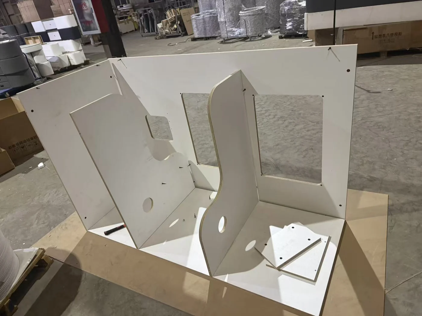 Real workshop photo of custom cat enclosure panels and internal dividers during assembly