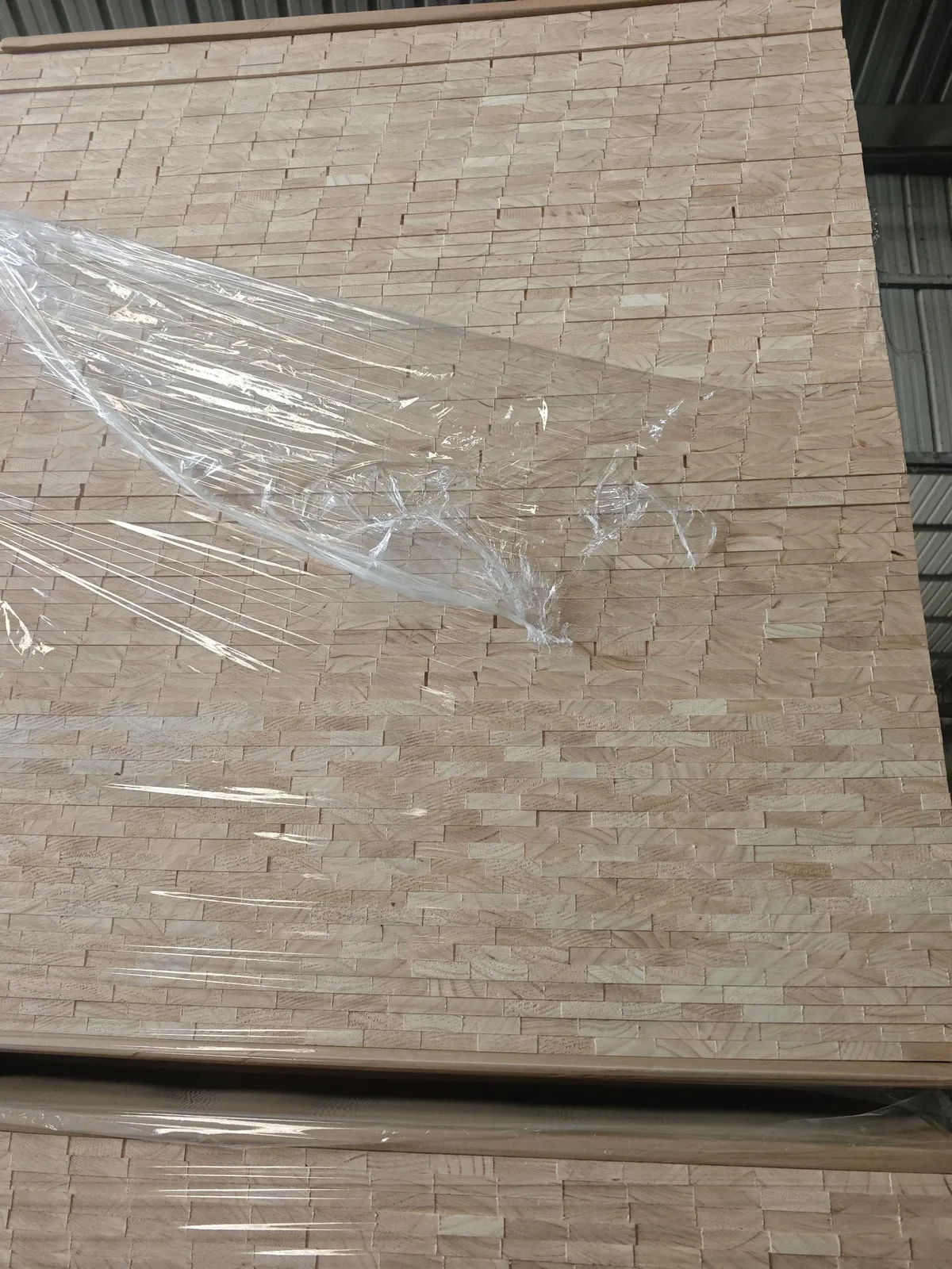 Pine finger-jointed panels stacked on pallet